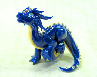 Illustration for article titled Adorable sculpted dragons guard your 20-sided dice